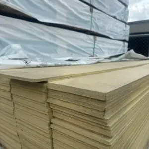 Stacked insulation boards under overcast sky.