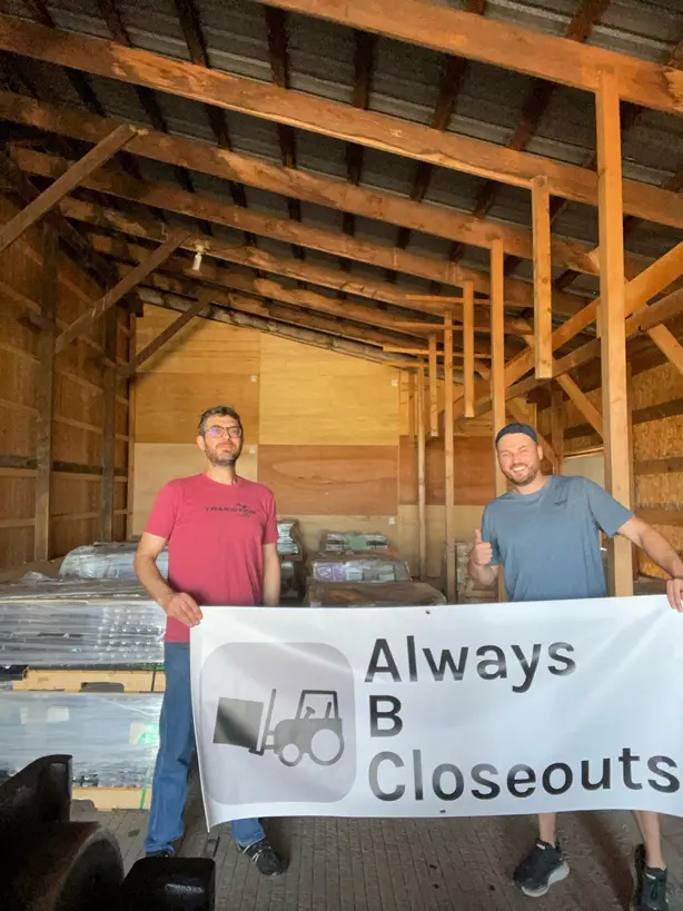 Two men holding "Always B Closeouts" banner.