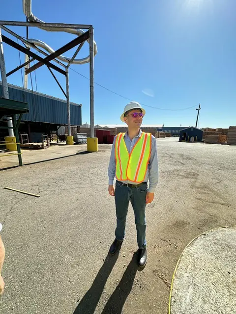 Person wearing safety gear at industrial site.