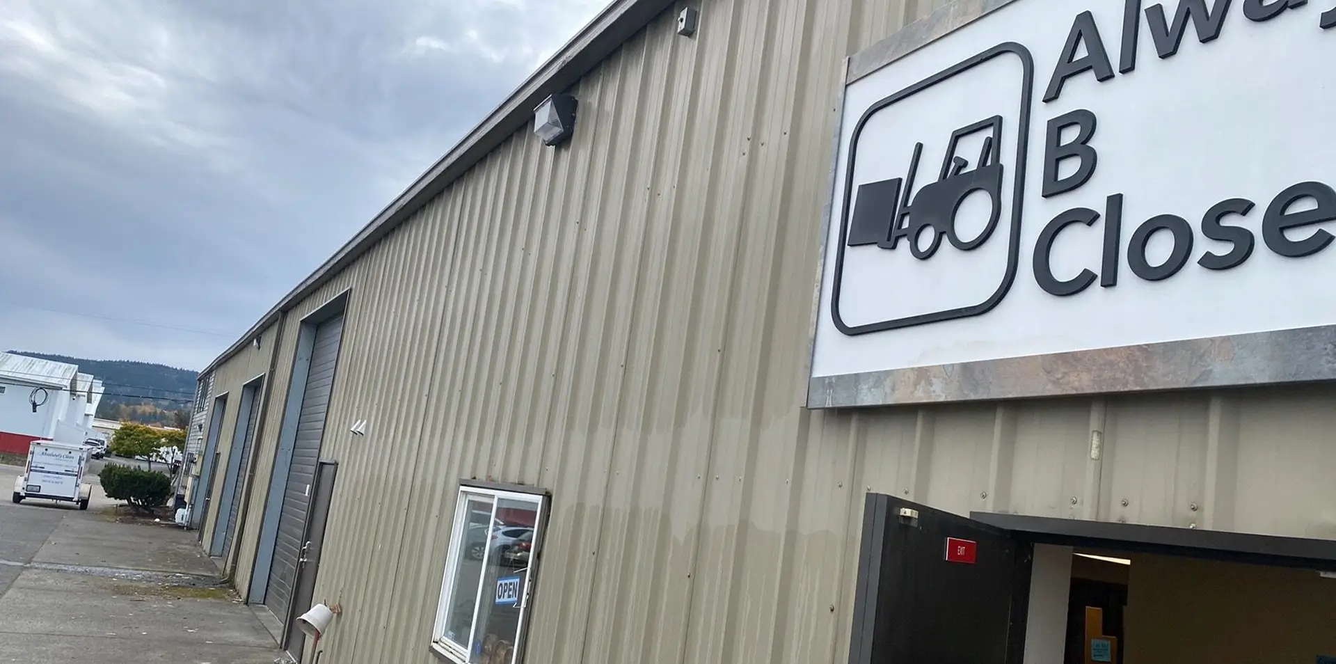Warehouse exterior with a forklift sign.